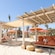 Cabanas featuring daybeds, hammocks, lounge chairs, tables and towels at a beach club